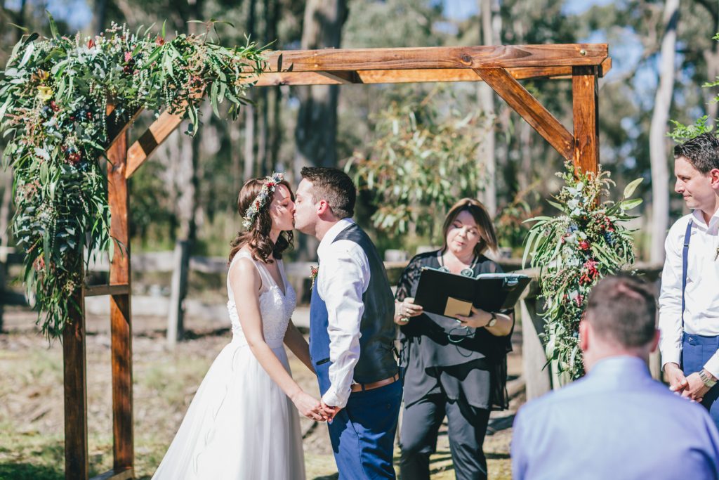 Bride and groom first kiss as husband and wife at Gunyah Valley wedding.