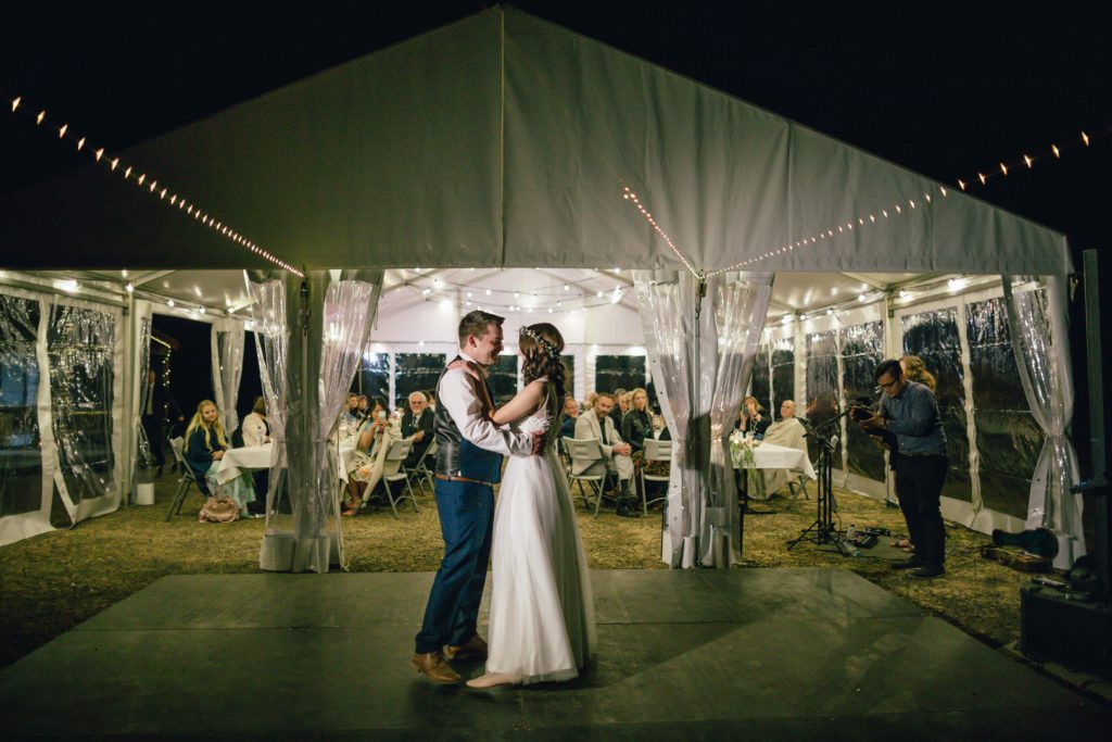 Outdoor reception where bride and groom share first dance as husband and wife at Gunyah Valley wedding.