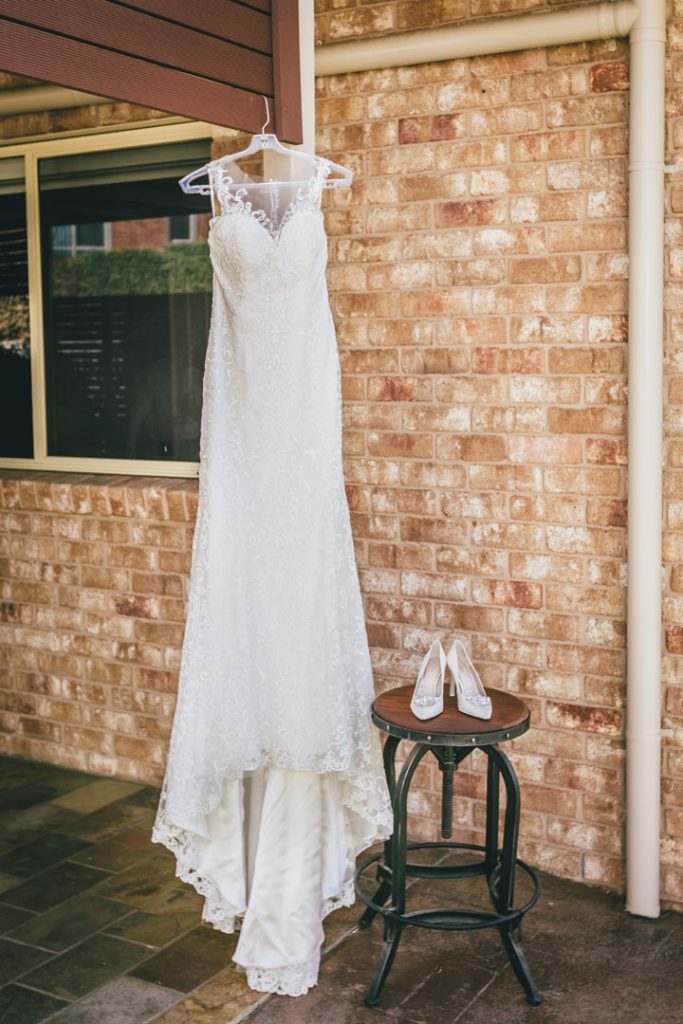 Wedding dress hanging from the wooden beam for Norton Estate wedding.
