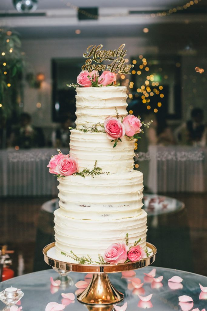 Beautiful rustic four-tier wedding cake with pink roses for a Poets Lane wedding.