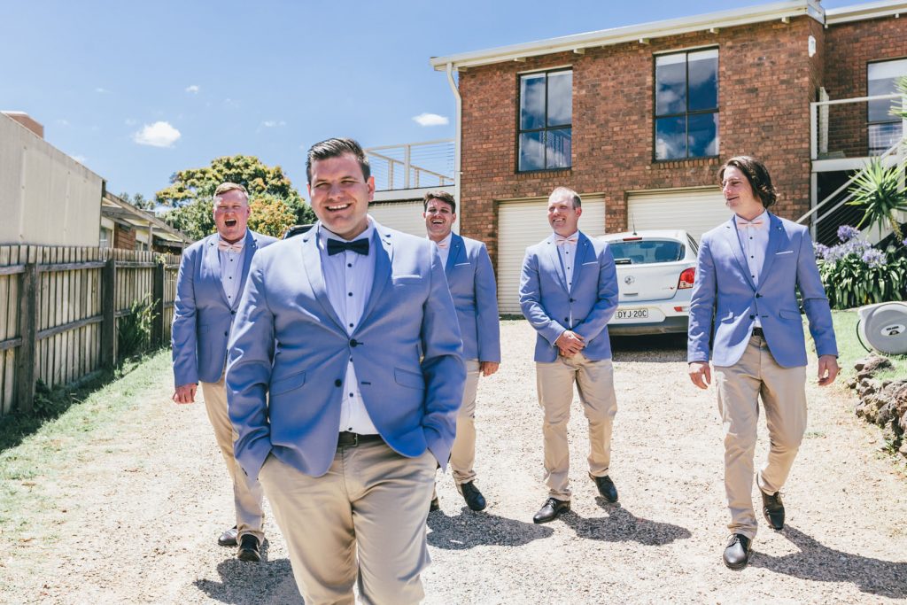Groom with his groomsmen posing during getting ready in the morning before wedding ceremony.