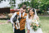 Wedding photo of Tiffany & Sol, posing with their beloved dog.