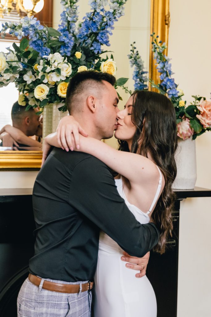 Bride and groom first kiss after becoming husband and wife at Registry Office wedding.