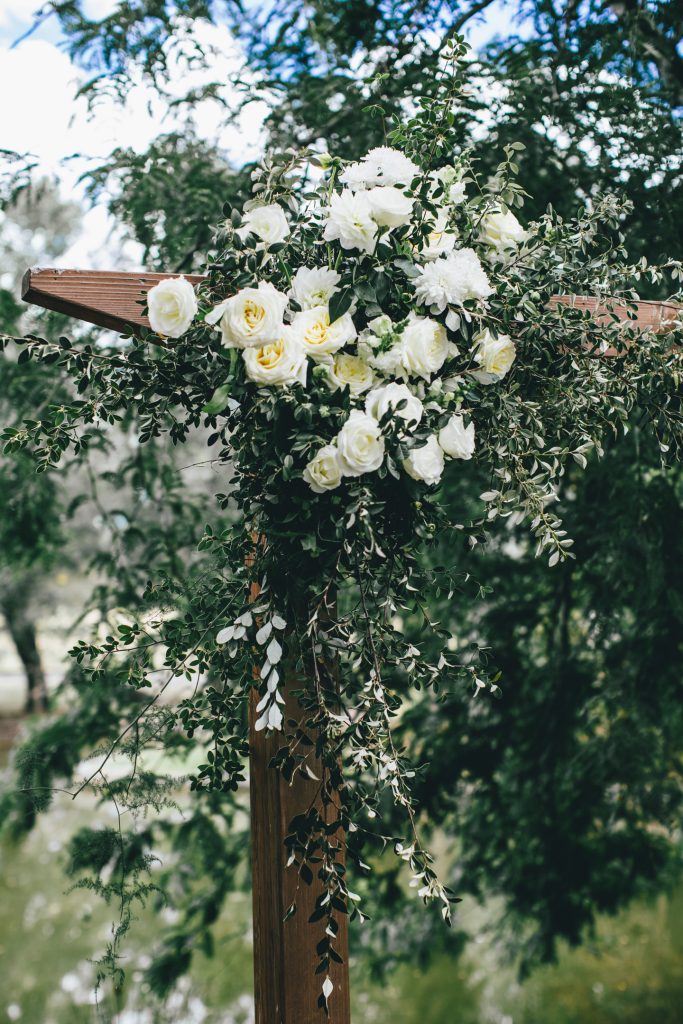 White roses on wooden wedding arch at Ravenswood Homestead Wedding.