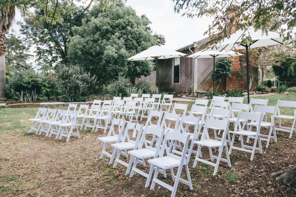White chairs for seating arrangements for outdoor weddings at Ravenswood Homestead Wedding.
