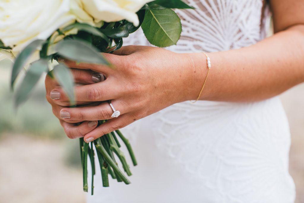 Photo of the engagement ring with bouquet.