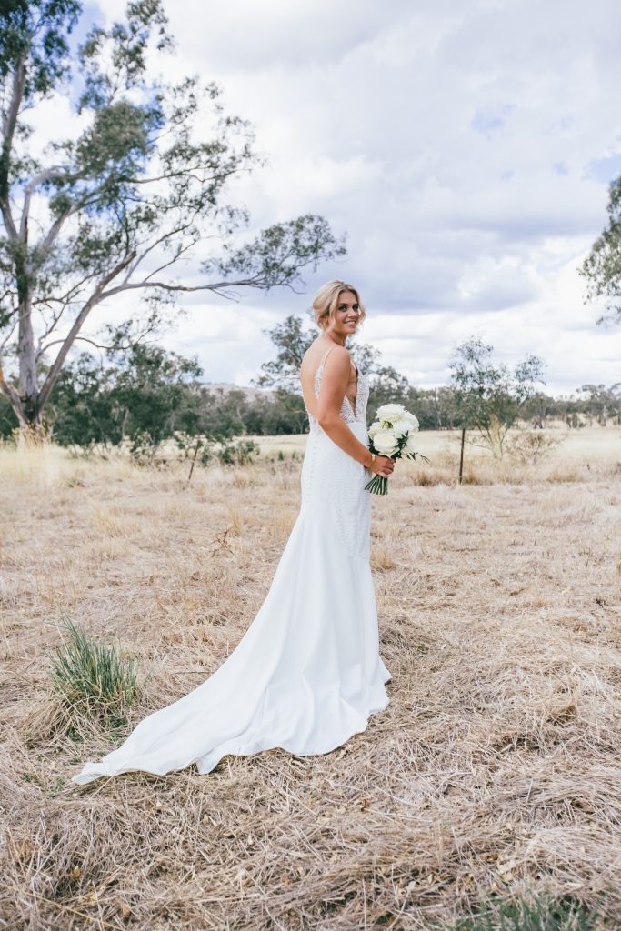 Outdoor bridal portrait pose with white flower bouquet at Ravenswood Homestead Wedding.