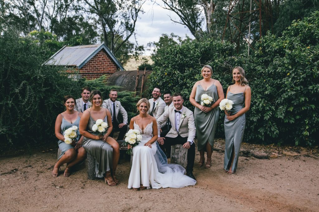 Bride, groom, bridesmaids and groomsmen photo session after wedding ceremony at Ravenswood Homestead Wedding.
