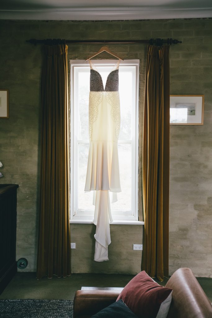 Wedding dress hanging from the window at Ravenswood Homestead Wedding.