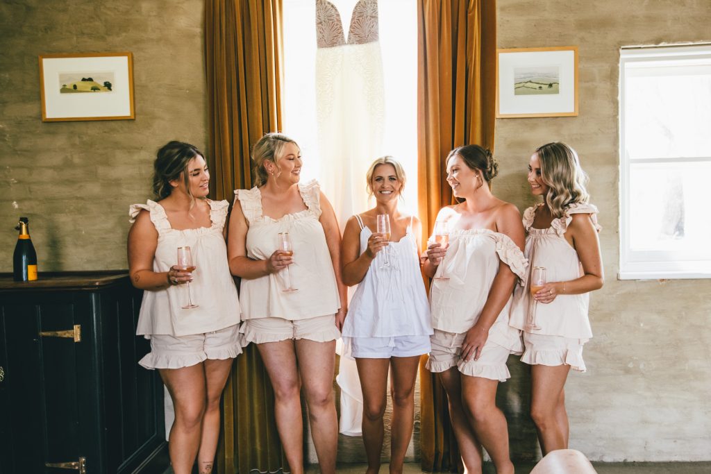 Bride and bridesmaids getting ready in robe at Ravenswood Homestead Wedding.