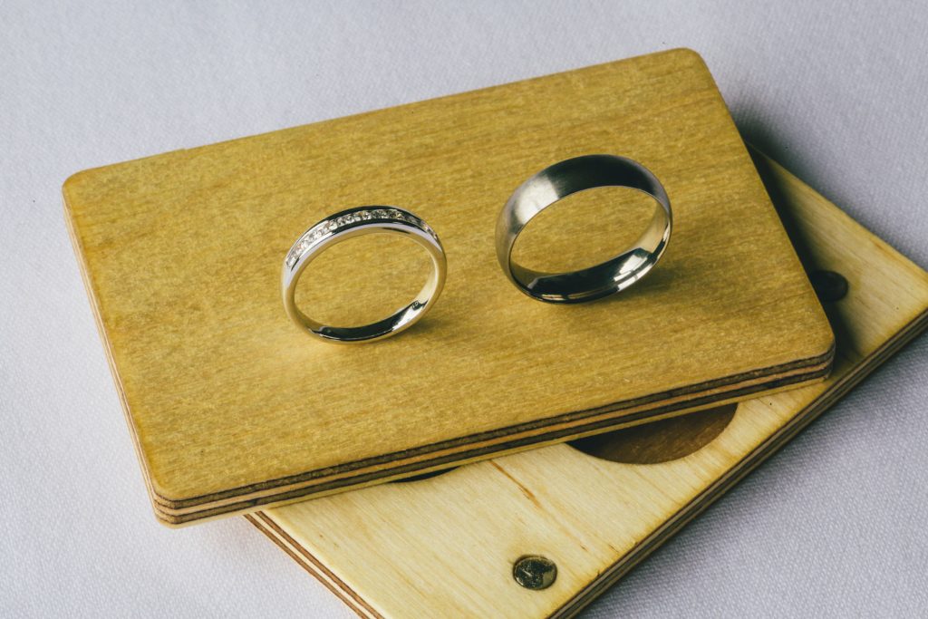 Wedding rings standing up with timber case.