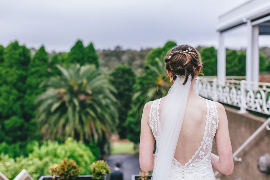 Beautiful bride from behind while looking at the scenery for Farm Vigano South Morang wedding