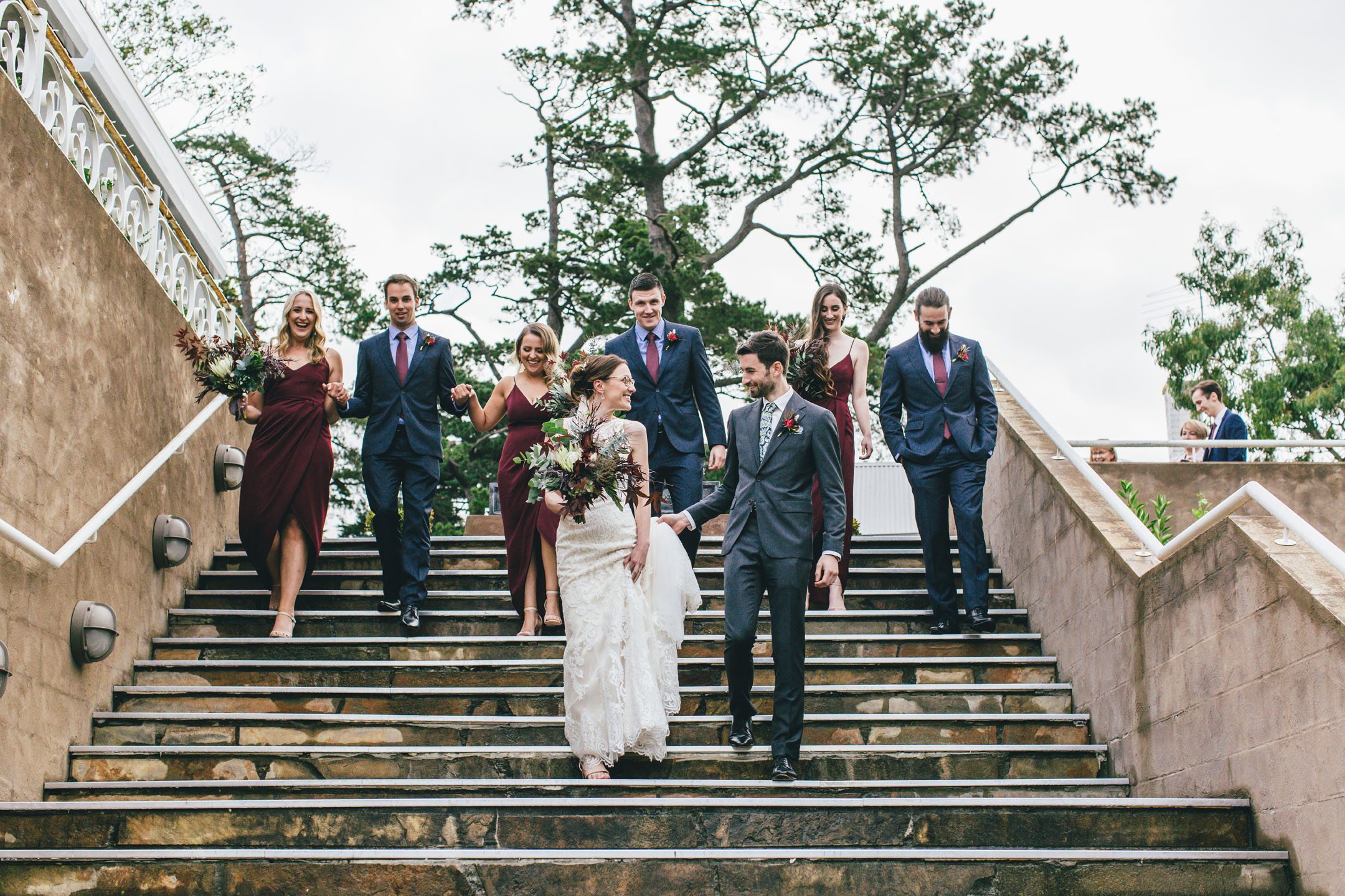 Bride & Groom walking down the stairs with their bridal party at Farm Vigano