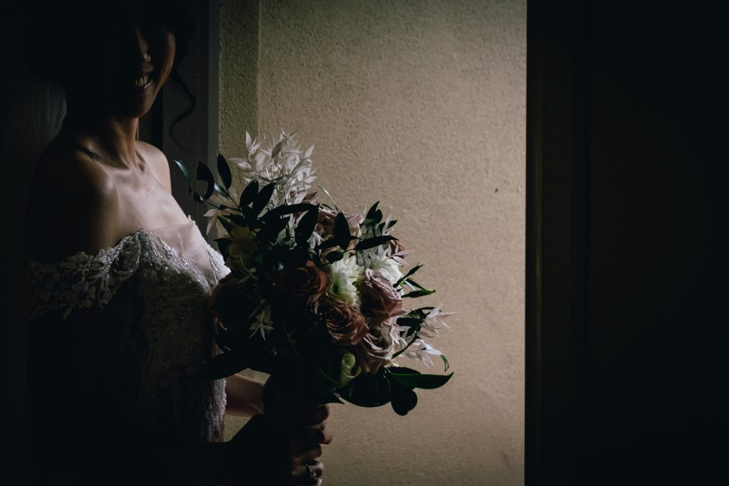 Bride holding her beautiful rustic bouquet of flowers.