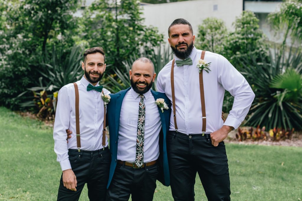Groom and his groomsmen posing before wedding ceremony.