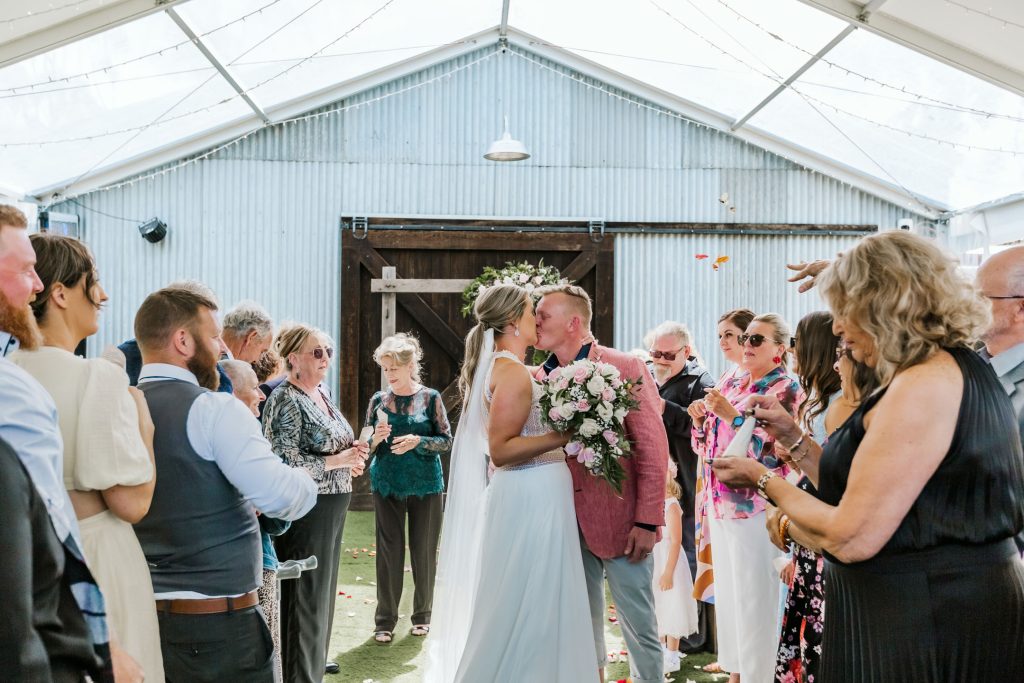 Bride and groom first kiss as husband and wife at Rocklea Farm wedding.