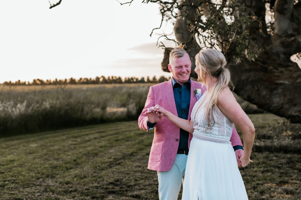 Bride and groom dancing in the middle of beautiful paddock during sunset at Rocklea Farm wedding.